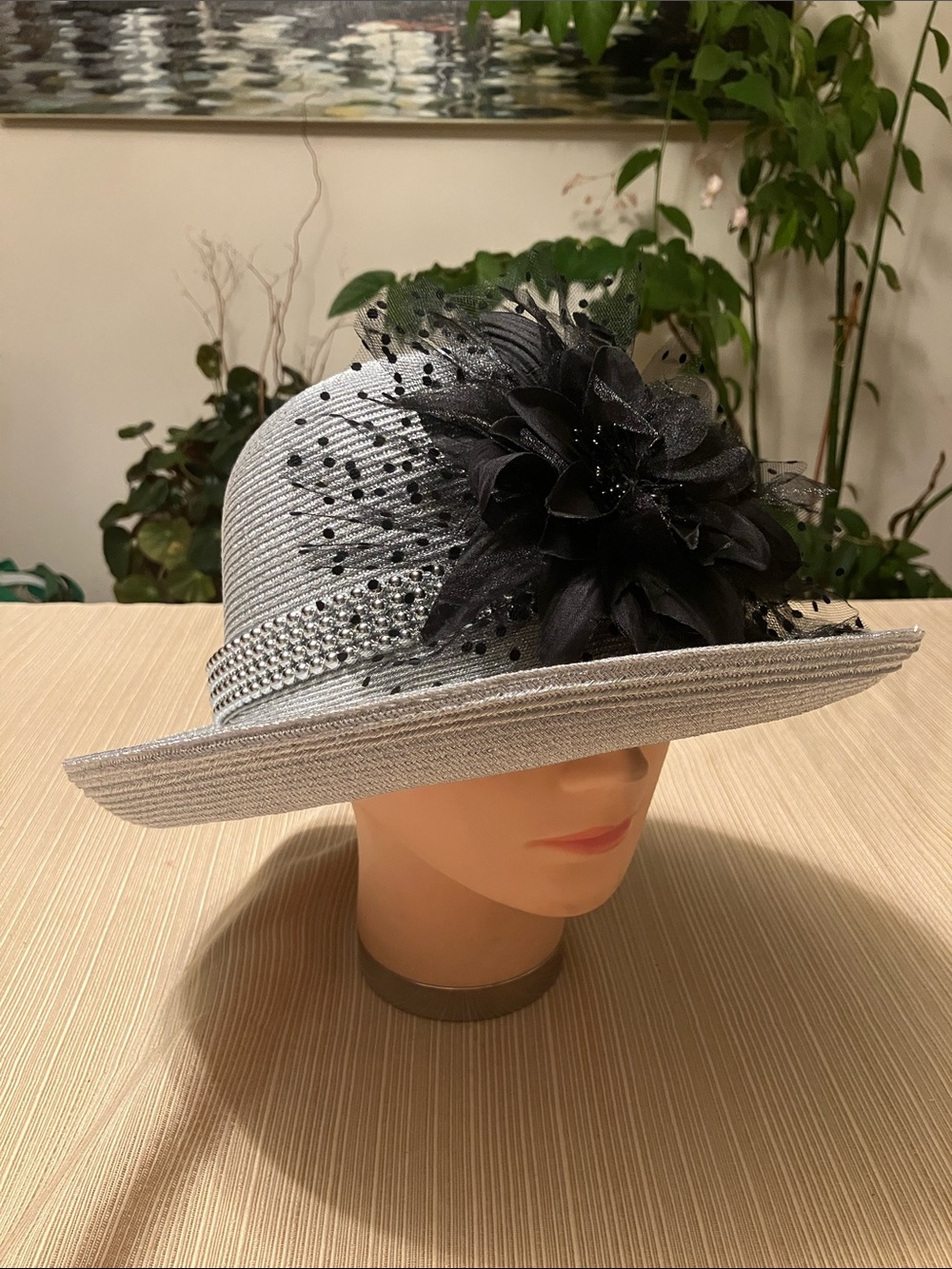 Elegant Metallic Silver Hat with Black Floral Accent And Silver Beaded Band